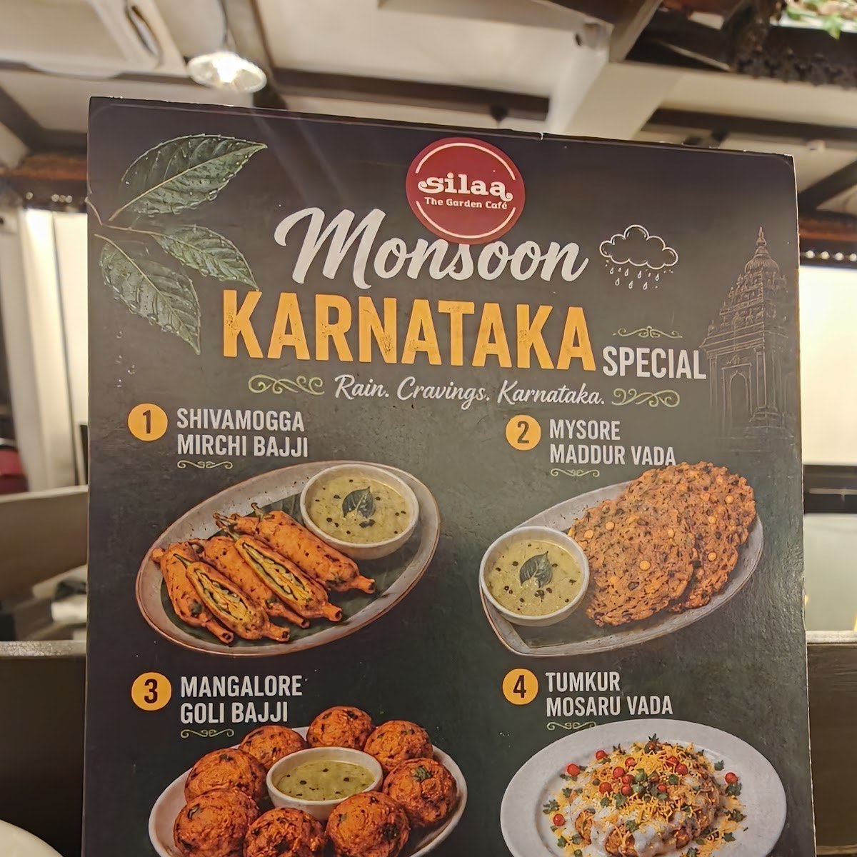 The in-store Monsoon Karnataka Special poster listing Shivamogga Mirchi Bajji, Mysore Maddur Vada, Mangalore Goli Bajji and Tumkur Mosaru Vada